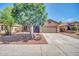 Charming single-Gathering home with desert landscaping, mature trees, and a two-car garage at 11318 W Monte Vista Rd, Avondale, AZ 85392