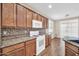 A kitchen featuring granite countertops, wood cabinets, tile backsplash, and stainless steel appliances at 11318 W Monte Vista Rd, Avondale, AZ 85392