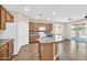 A kitchen featuring an island, stainless steel appliances, granite countertops, and wood cabinets at 11318 W Monte Vista Rd, Avondale, AZ 85392