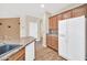 A kitchen with wood cabinets, granite countertops, stainless steel appliances and wood flooring at 11318 W Monte Vista Rd, Avondale, AZ 85392