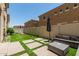 Backyard with artificial grass, pavers, modern patio furniture, and privacy fence at 1367 S Country Club Dr # 1331, Mesa, AZ 85210