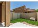 Fenced backyard with artificial turf creating a serene, low-maintenance outdoor space with a charming garden bench at 1367 S Country Club Dr # 1331, Mesa, AZ 85210