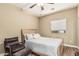 Bedroom featuring a light wood bed, wood floors, comfortable chair, and bright window at 1367 S Country Club Dr # 1331, Mesa, AZ 85210