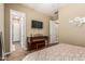 Bedroom featuring a piano, TV, and wood-look flooring, creating a comfortable and inviting space at 1367 S Country Club Dr # 1331, Mesa, AZ 85210