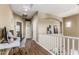 Hallway with desk space, storage closet, wood-look flooring and white railing at 1367 S Country Club Dr # 1331, Mesa, AZ 85210