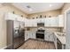 Well-lit kitchen with granite counters, stainless appliances, and white cabinetry at 1367 S Country Club Dr # 1331, Mesa, AZ 85210