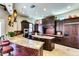 Modern kitchen features a curved breakfast bar with granite countertops, dark wood cabinetry, and stainless steel appliances at 1367 S Country Club Dr # 1331, Mesa, AZ 85210