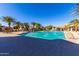 Expansive community pool with lounge chairs, palm trees, and a water fountain, providing a relaxing oasis at 1367 S Country Club Dr # 1331, Mesa, AZ 85210