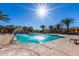 Stunning community pool featuring a water fountain, surrounded by lounge chairs and palm trees at 1367 S Country Club Dr # 1331, Mesa, AZ 85210