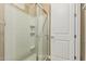 Walk-in shower with white tiled walls, glass door, and convenient built-in seat at 1367 S Country Club Dr # 1331, Mesa, AZ 85210