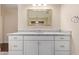 Bright bathroom features a white vanity with marble countertop, ample storage, a large mirror, and modern lighting at 152 W 2Nd St, Mesa, AZ 85201