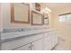 A bright bathroom with marble countertops and white cabinets at 152 W 2Nd St, Mesa, AZ 85201