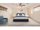 Bright bedroom boasts a ceiling fan, neutral paint, three windows, and a nicely decorated and comfortable bed at 152 W 2Nd St, Mesa, AZ 85201