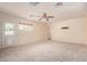 Large bonus room features neutral paint, a ceiling fan, carpet flooring, and a back door leading to the exterior at 152 W 2Nd St, Mesa, AZ 85201