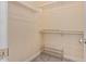 Small closet features neutral paint, carpet flooring, shelving on the walls, and shoe shelving on the floor at 152 W 2Nd St, Mesa, AZ 85201