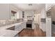 Bright kitchen featuring white cabinetry, granite countertops, stainless steel appliances, and wood floors at 152 W 2Nd St, Mesa, AZ 85201