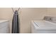 The laundry room has a washer, dryer, and ironing board at 152 W 2Nd St, Mesa, AZ 85201