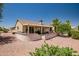 Backyard features a covered patio, desert landscaping, and a privacy wall at 15314 W Pantano Dr, Surprise, AZ 85374