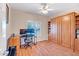 A guest bedroom offering versatility with a built-in murphy bed and wood flooring at 15314 W Pantano Dr, Surprise, AZ 85374