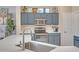 Updated kitchen with stainless steel appliances and stylish blue cabinetry at 15314 W Pantano Dr, Surprise, AZ 85374