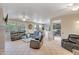 Spacious living room with tile flooring, ceiling fan, and a view of the kitchen at 15314 W Pantano Dr, Surprise, AZ 85374
