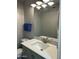 Bright half bath featuring a modern vanity and mirror with decorative lighting at 1734 W Tuckey Ln # 14, Phoenix, AZ 85015