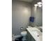 Well-lit half bathroom featuring a toilet and a sink with a vanity and tile accents at 1734 W Tuckey Ln # 14, Phoenix, AZ 85015