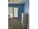 Carpeted room with door to patio area, updated with a white dresser and neutral walls at 1734 W Tuckey Ln # 14, Phoenix, AZ 85015