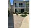 Beautiful two-story building with well-maintained landscaping, stone accents, and brick walkways at 1734 W Tuckey Ln # 14, Phoenix, AZ 85015