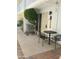 This cozy front porch features a small table and chairs, and small ornamental tree at 1734 W Tuckey Ln # 14, Phoenix, AZ 85015