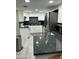 Modern kitchen featuring stainless steel appliances, granite countertops, and white cabinetry at 1734 W Tuckey Ln # 14, Phoenix, AZ 85015