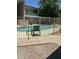 Community swimming pool with a metal fence, lounging chairs, and convenient walkways at 1734 W Tuckey Ln # 14, Phoenix, AZ 85015