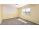 Bright bedroom featuring neutral carpet, a ceiling fan, and large sunny windows at 1862 E Tulane Dr, Tempe, AZ 85283