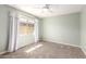 Carpeted bedroom featuring a ceiling fan, light green walls, and window with curtains at 1862 E Tulane Dr, Tempe, AZ 85283