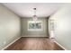 Bright dining room featuring wood-look floors and elegant chandelier at 1862 E Tulane Dr, Tempe, AZ 85283