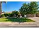 Charming single story home showcasing a well-manicured lawn, mature trees, and inviting curb appeal at 1862 E Tulane Dr, Tempe, AZ 85283