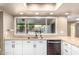 Kitchen sink features granite counters and a large window overlooking backyard at 1862 E Tulane Dr, Tempe, AZ 85283