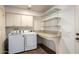 Well-lit laundry room with washer, dryer, shelving and countertops at 1862 E Tulane Dr, Tempe, AZ 85283