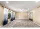Bright living room featuring neutral paint, a ceiling fan, carpet floors, and arched doorway at 1862 E Tulane Dr, Tempe, AZ 85283