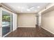 Cozy room featuring wood floors, sliding door to the pool, ceiling fan, and neutral paint at 1862 E Tulane Dr, Tempe, AZ 85283
