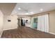 Living area with wood floors, a ceiling fan, and a view of the kitchen and sliding door to the patio at 1862 E Tulane Dr, Tempe, AZ 85283