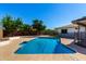 Sparkling in-ground pool surrounded by a patio and lush landscaping, perfect for outdoor enjoyment at 1862 E Tulane Dr, Tempe, AZ 85283