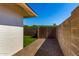 Paver stones leading to a metal gate in the side yard, with a white block wall at 1862 E Tulane Dr, Tempe, AZ 85283