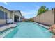 Backyard featuring a custom pool with rock waterfall feature, providing the ultimate in outdoor enjoyment at 19606 W Grant St, Buckeye, AZ 85326