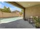 Covered patio view to refreshing pool with custom rock waterfall feature, perfect for outdoor living at 19606 W Grant St, Buckeye, AZ 85326