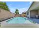 Beautiful pool featuring beach entry, rock waterfall, and well maintained desert landscaping for added privacy at 19606 W Grant St, Buckeye, AZ 85326