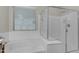 Clean and modern bathroom with a luxurious soaking tub and separate shower with glass enclosure at 19606 W Grant St, Buckeye, AZ 85326