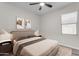 Cozy bedroom features a comfortable bed with decorative pillows and natural light streaming through the window at 19606 W Grant St, Buckeye, AZ 85326