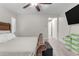 Spacious bedroom featuring sleek ceiling fan and a bed with rustic wood detailing at 19606 W Grant St, Buckeye, AZ 85326