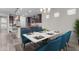 Bright dining room featuring a modern table, blue chairs, and natural light at 19606 W Grant St, Buckeye, AZ 85326